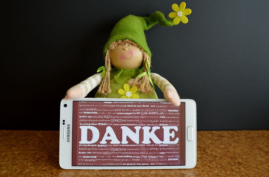 white Samsung smartphone screen displaying Danke, thank you, greeting card