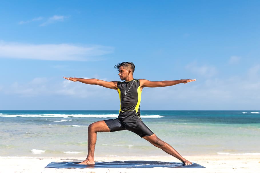 Man in Sleeveless Wet Suit Doing Some Aerobics at the Beach, adult