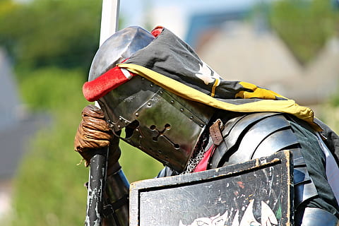 person wearing armor and helmet while holding shield and spear HD wallpaper