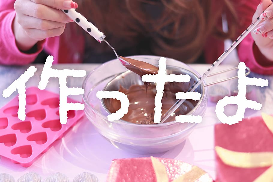 person holding spoon with chocolate syrup and bowl filled with melted chocolate HD wallpaper