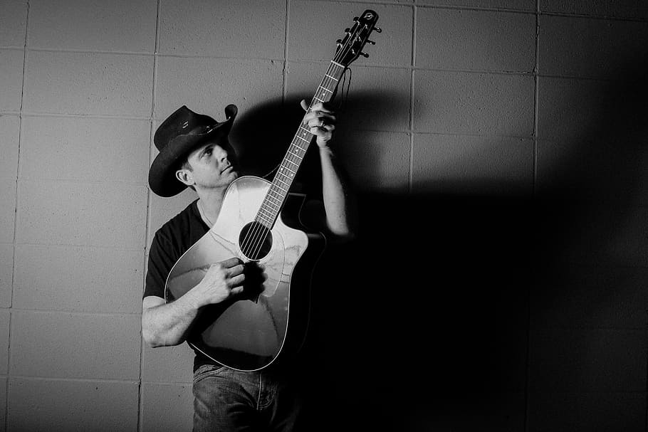 grayscale photography of man carrying guitar, men, cowboy, male