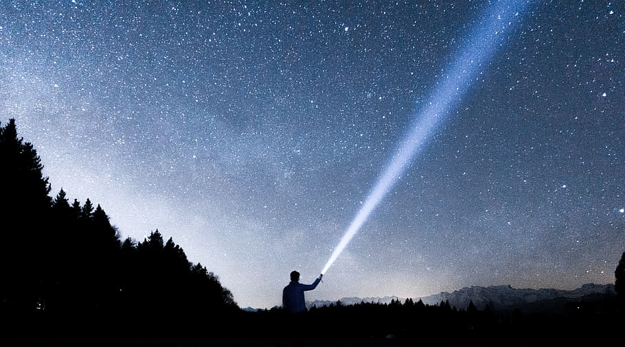 silhouette of person holding flashlight during nighttime, silhouette of man holding flashlight pointing in sky during night HD wallpaper