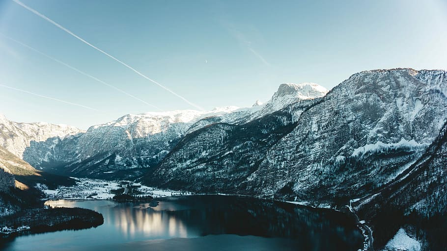 aerial view of body of water, snow covered mountain during daytime HD wallpaper