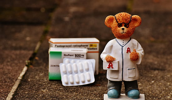 doctor bear figurine near boxes of medicine digital wallpaper HD wallpaper
