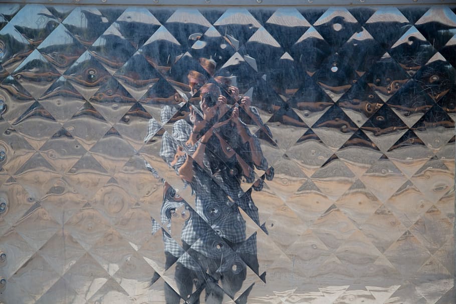 person taking picture on glass wall, mirror with reflection of a man in front taking picture HD wallpaper