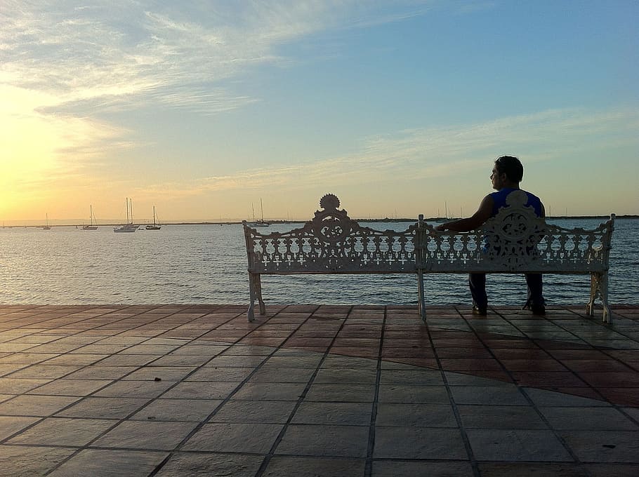 man sitting on bench beside body of water, los cabos, peace HD wallpaper