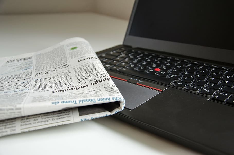 newspaper beside black Lenovo thinkpad, computer, read, information HD wallpaper