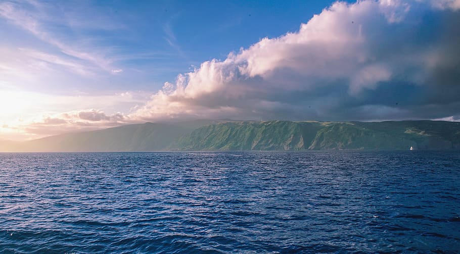 body of water under cloudy sky, clear body of water across mountain HD wallpaper