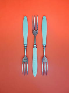 three silver forks on orange surface, background, breakfast HD wallpaper