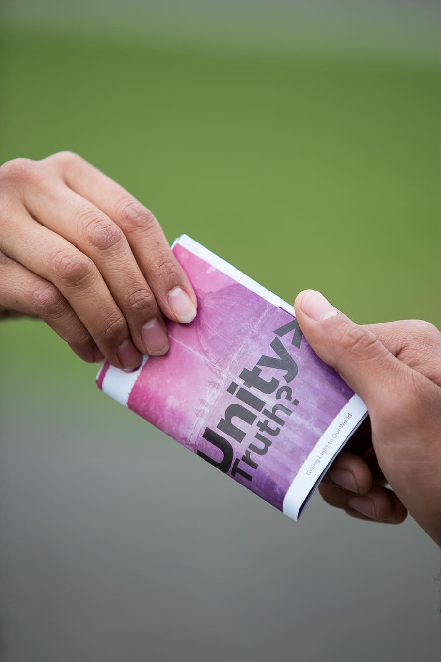 selective focus photography of two persons holding purple and white Unity truth? booklet, Unity Truth book HD wallpaper
