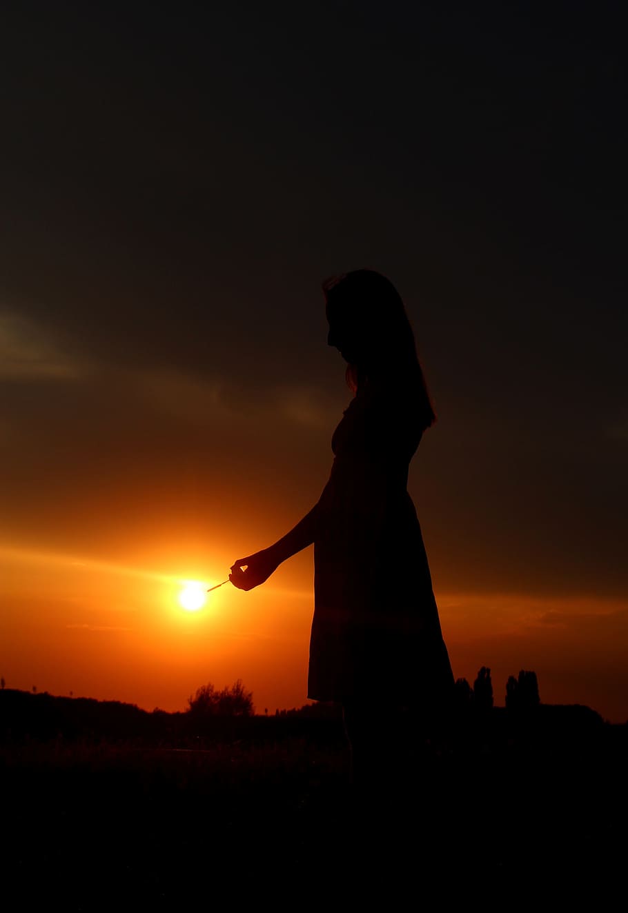 silhouette of woman during orange sunset lowlight photography HD wallpaper