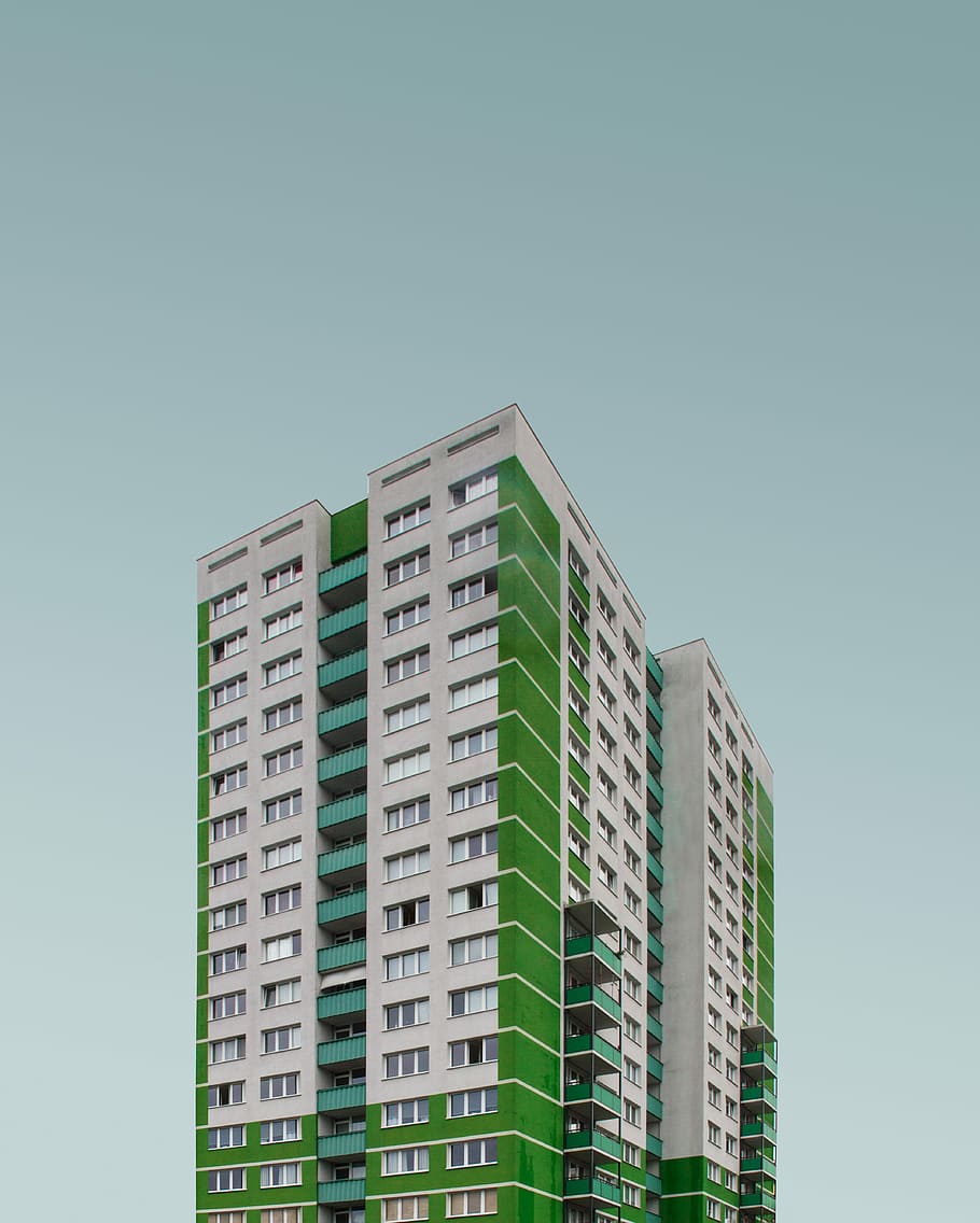 green and white concrete high-rise building at daytime, high-rise building under blue sky HD wallpaper