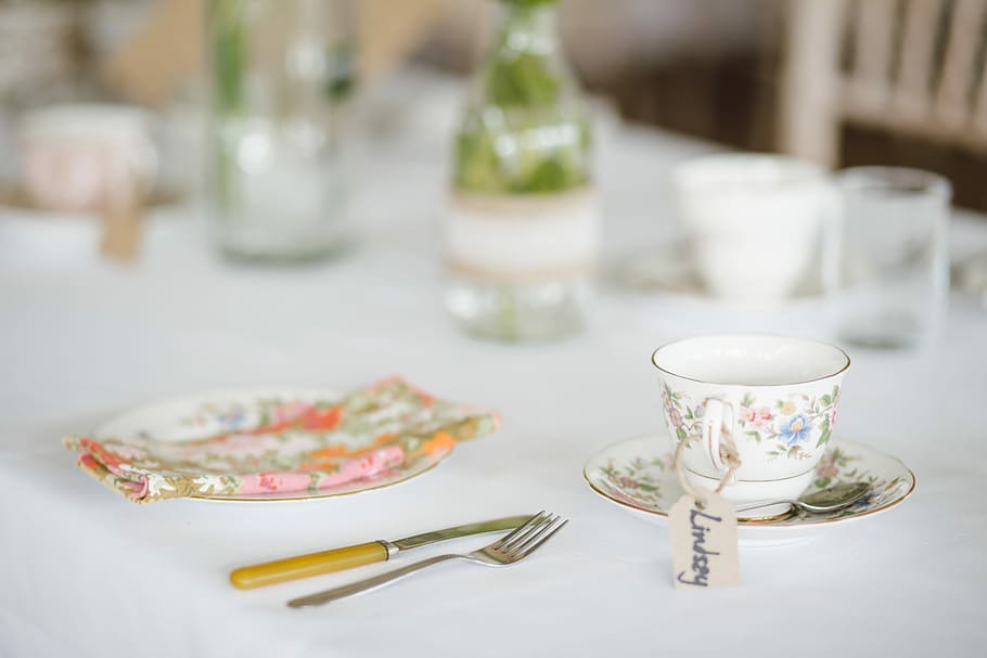 white and silver tableware on top of white wooden table, white ceramic cup and saucer near fork and butter knife on table HD wallpaper