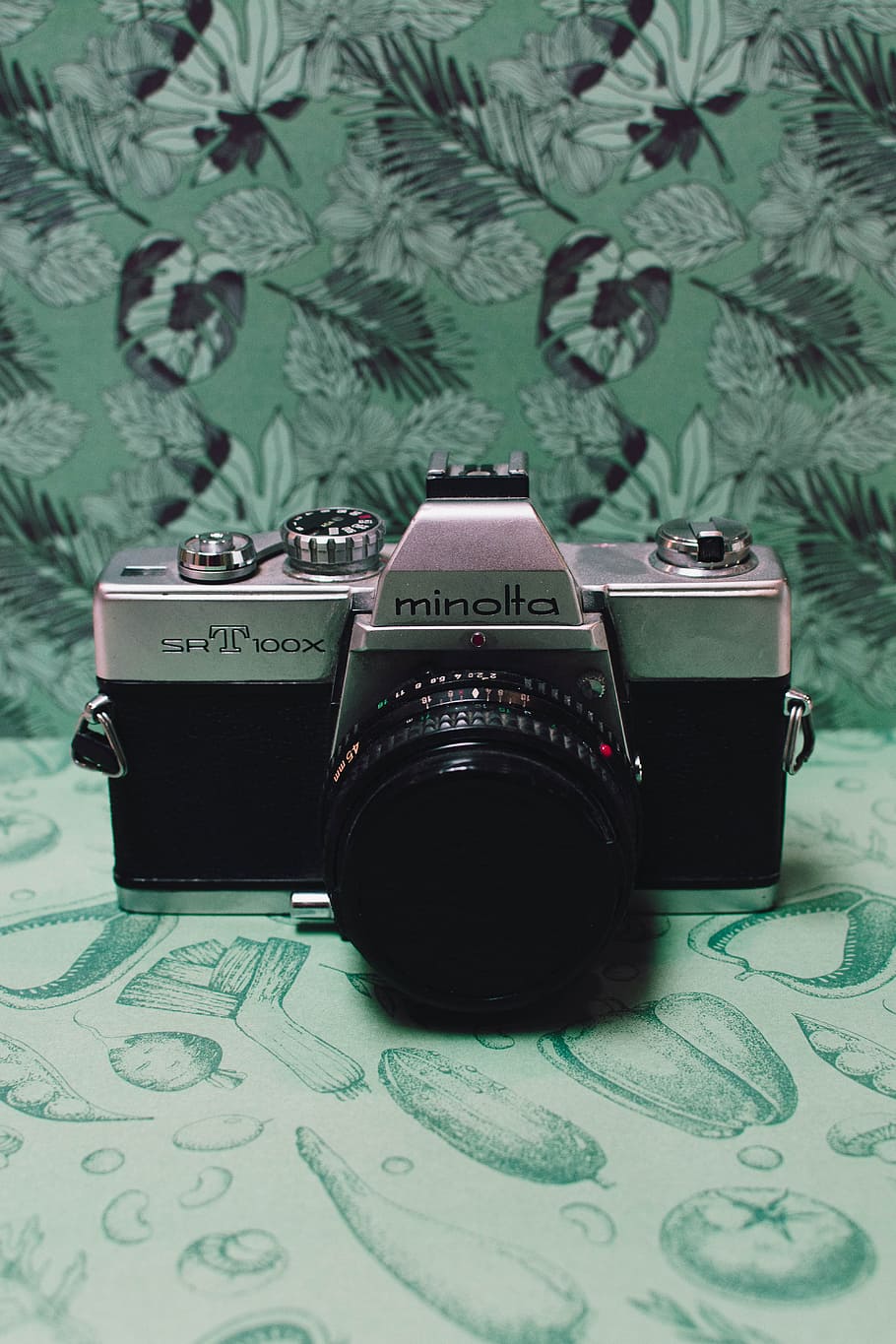 Black and Gray Film Camera on Green Floral Textile, analog, analog camera, HD wallpaper