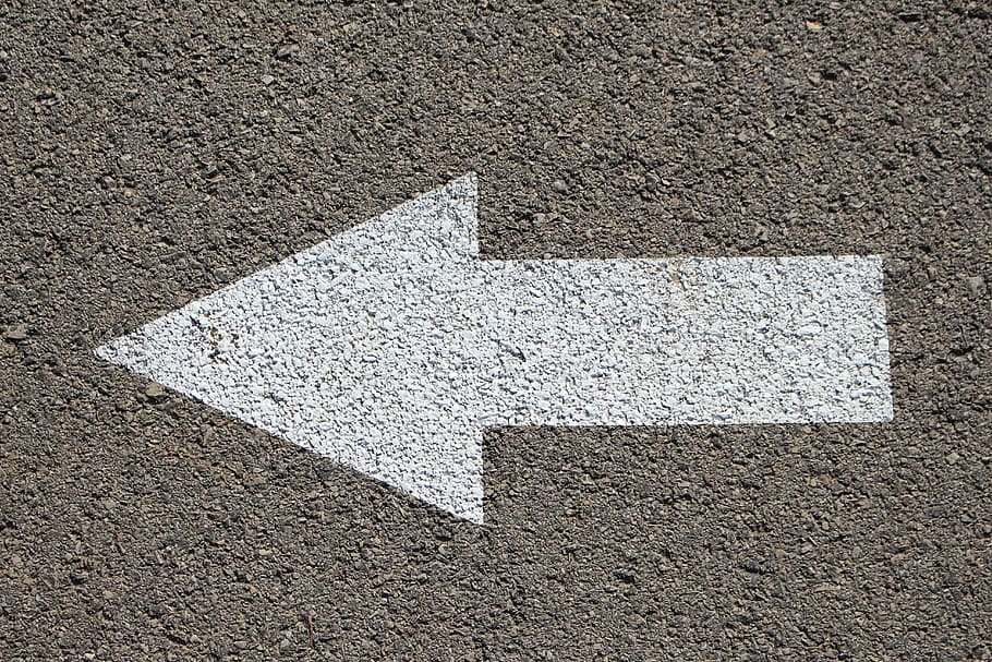 gray concrete surface with white arrow pointing at left side HD wallpaper