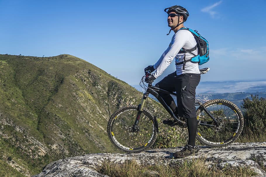 HD wallpaper man in white shirt riding bicycle on hill bike