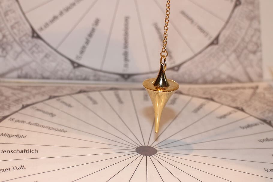 gold-colored hanging accessory near chart papers, pendulum HD wallpaper