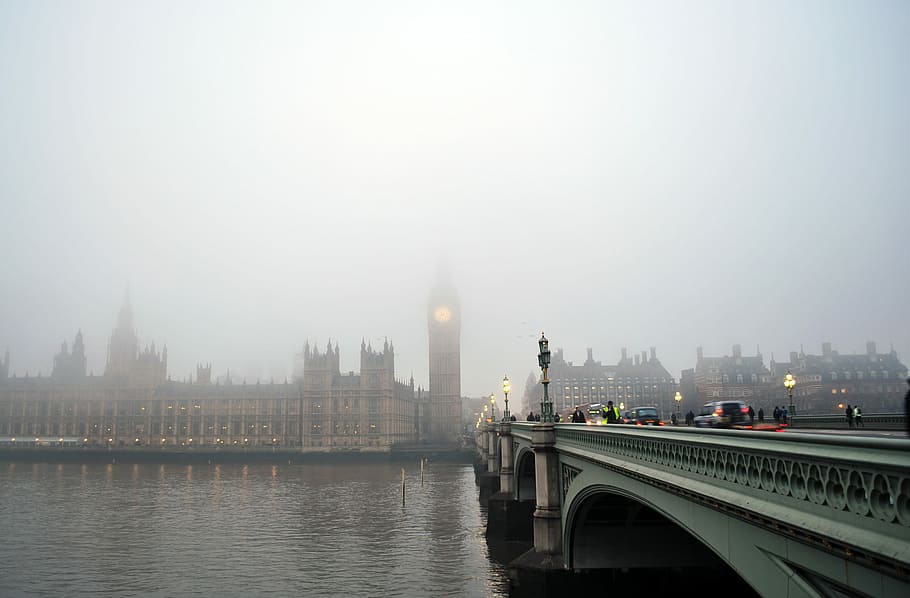 gray bridge towards Big Ben under gray sky, landscape photography of bridge and Big Ben with fogs