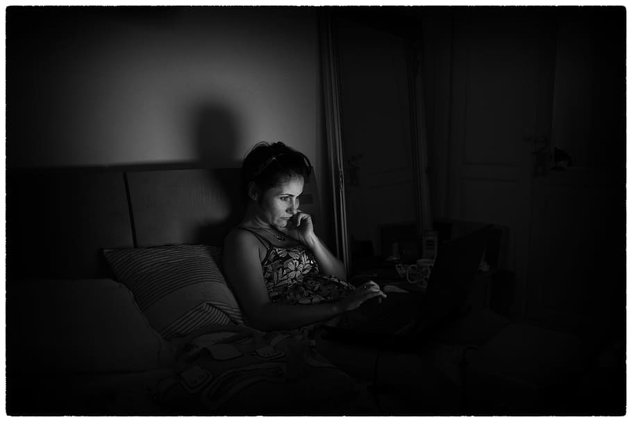 grayscale photograph of woman lying on bed using laptop, computer HD wallpaper