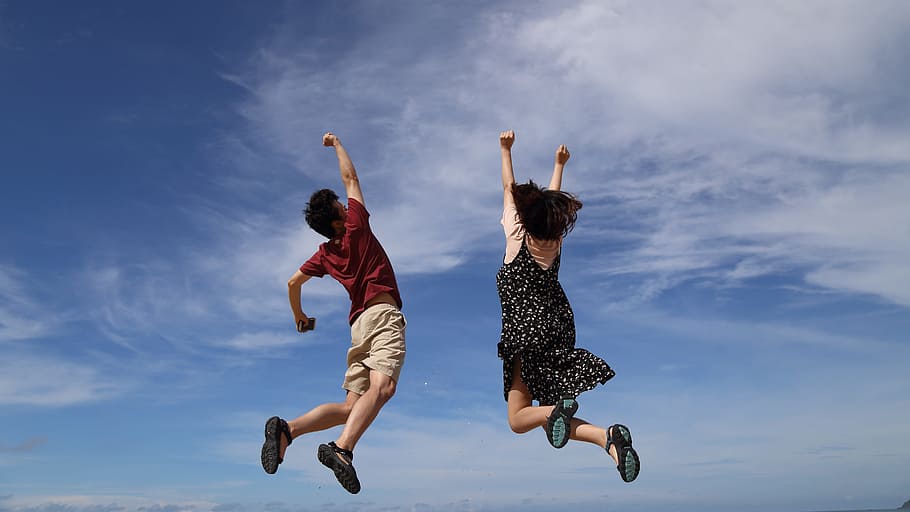 man and woman jumps with hands upwards, sky, hooray, cloud, blue