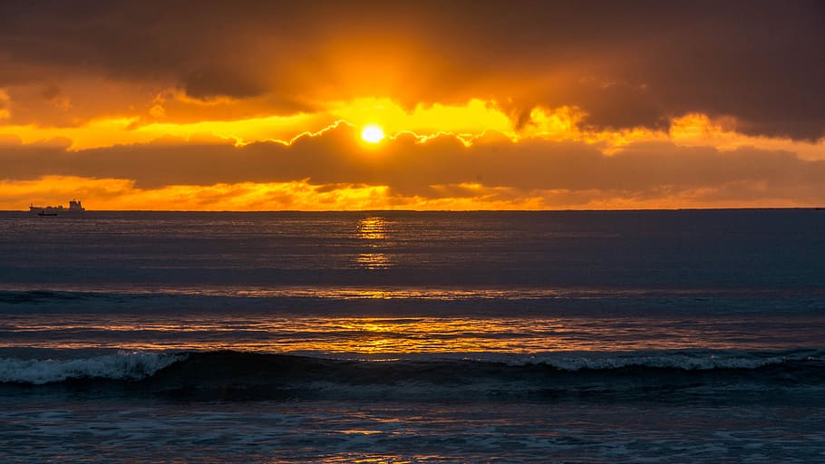 Sunrise at Camboriu Beach, waves rushed to shore at sunsset, sunset