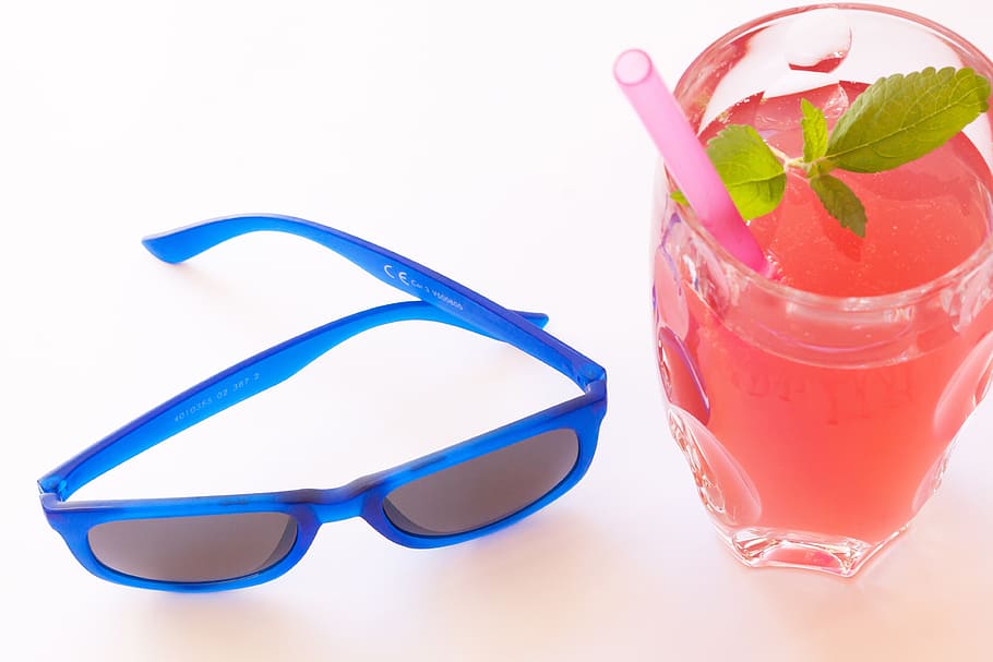 blue framed Wayfarer-style sunglasses near glass cup with juice drink HD wallpaper