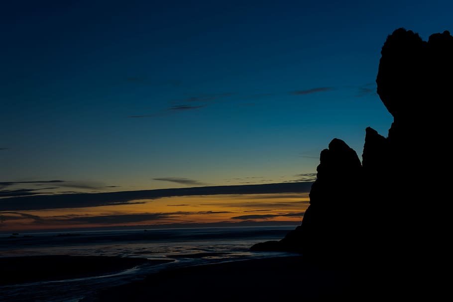 Twighlight at Ruby Beach, silhouette photo of rock formation near body of water