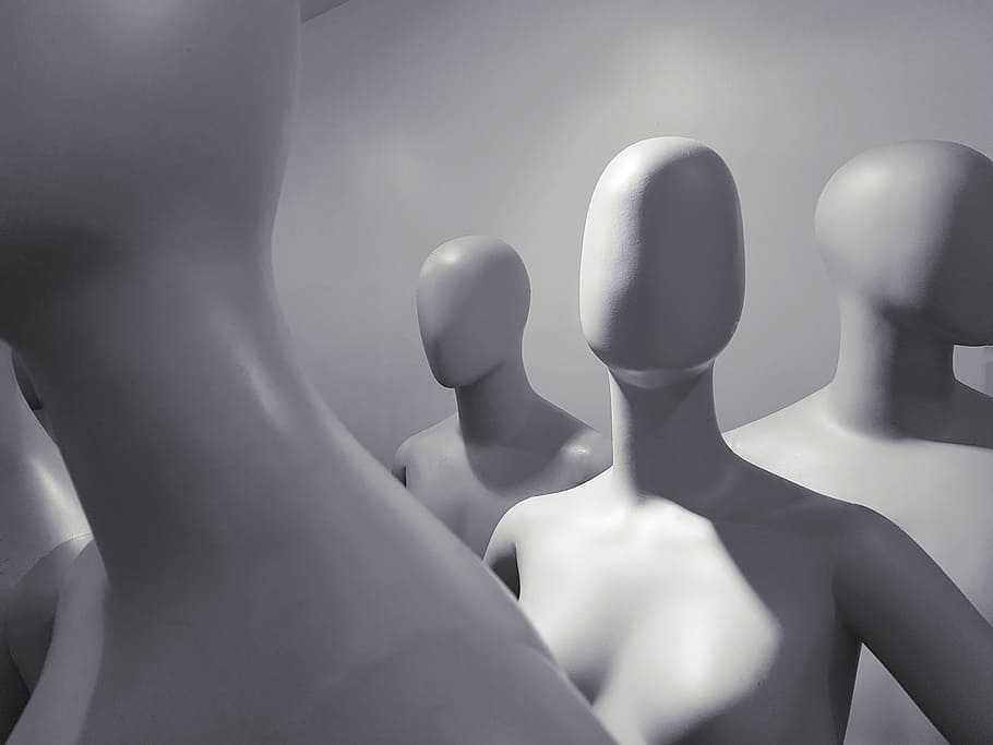selective focus photo of white mannequins inside white room, alone