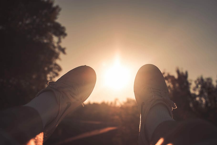person wearing white Nike lace-up sneakers during golden hour, person taking photo of its white shoes during golden hour, HD wallpaper