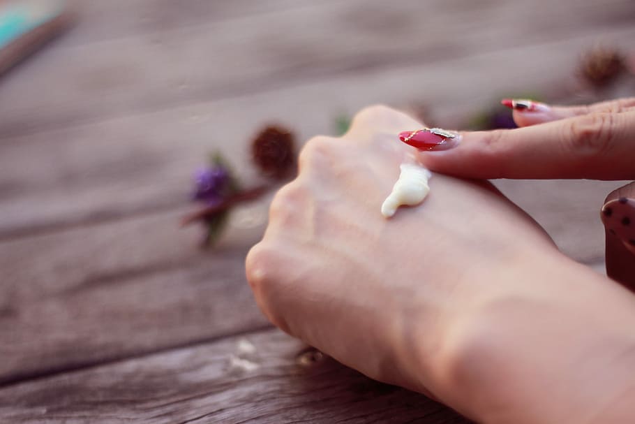 person putting lotion on arm knuckl, human Hand, women, close-up HD wallpaper