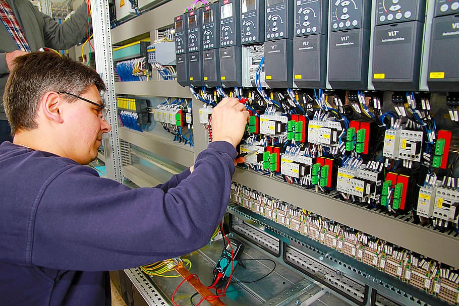 person fixing circuit breaker, control cabinet, power plant, automation