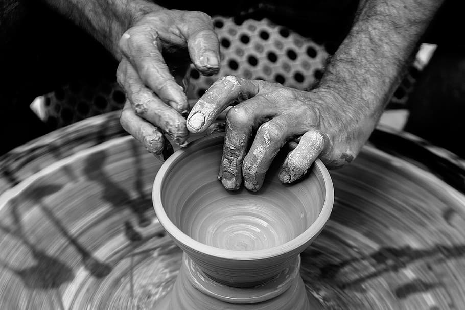 brown clay pot, greyscale photography of person molding clay pot