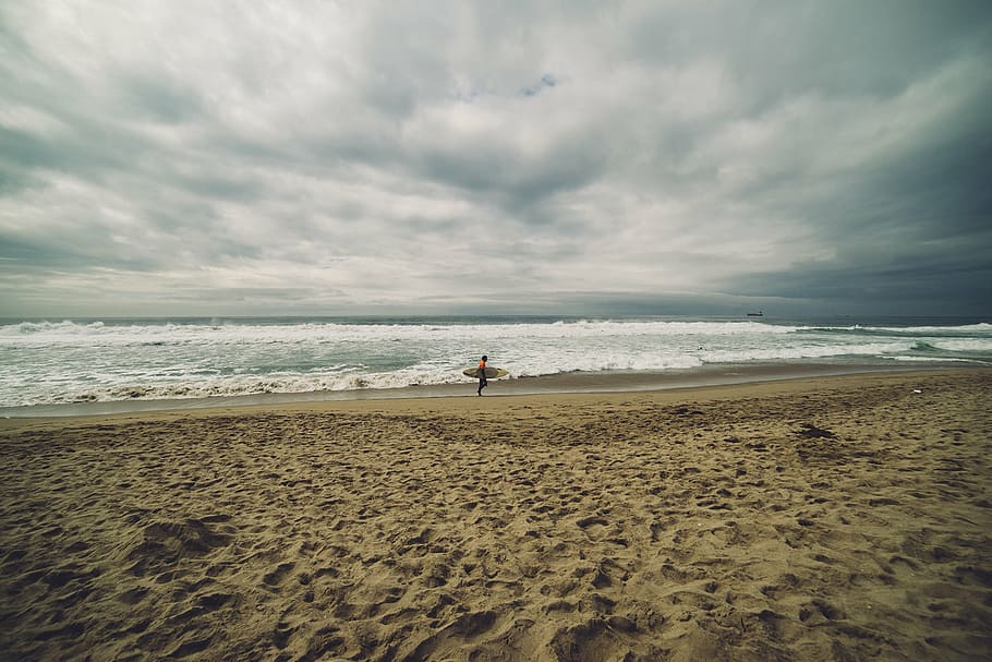 person on beach, man, standing, seaside, holding, surfboard HD wallpaper