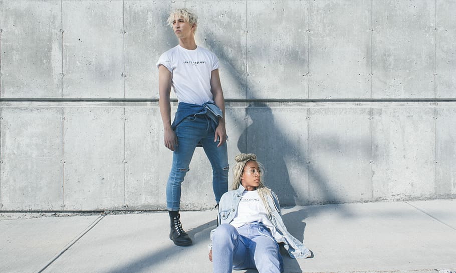 woman and man posing for photoshoot, man and woman wearing white t-shirts at daytime