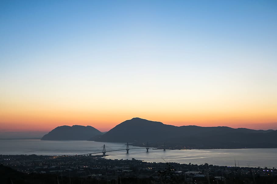 aerial photo of concrete bridge during golden hour, aerial photo of bridge near mountains HD wallpaper