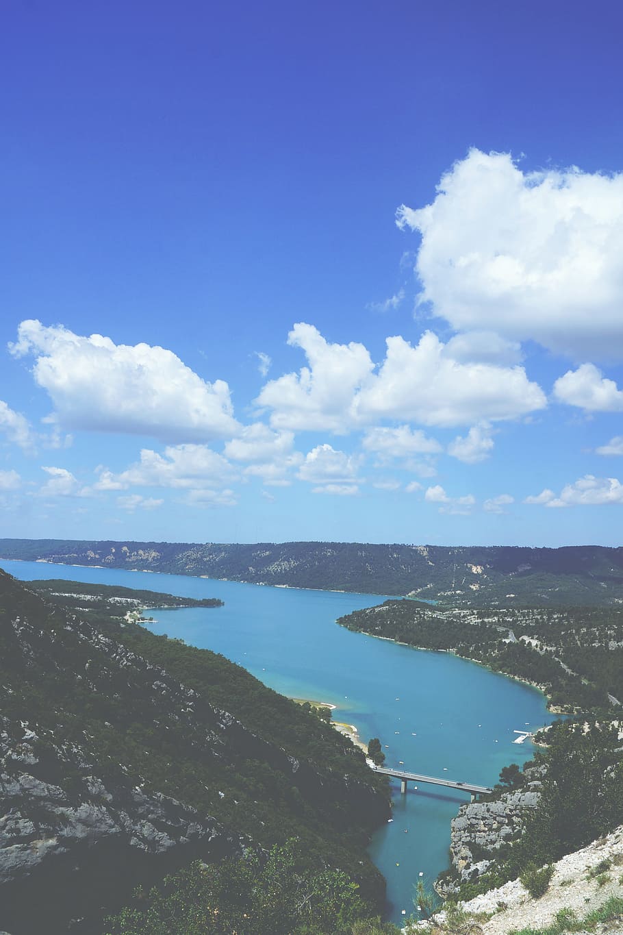 aerial photo of a body of water, bird's eye view photo of body between within mountain ranges during daytime HD wallpaper