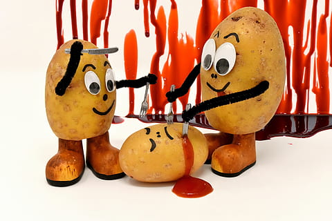 Potato in panic fear of a sharp armor knife - a Royalty Free Stock Photo  from Photocase