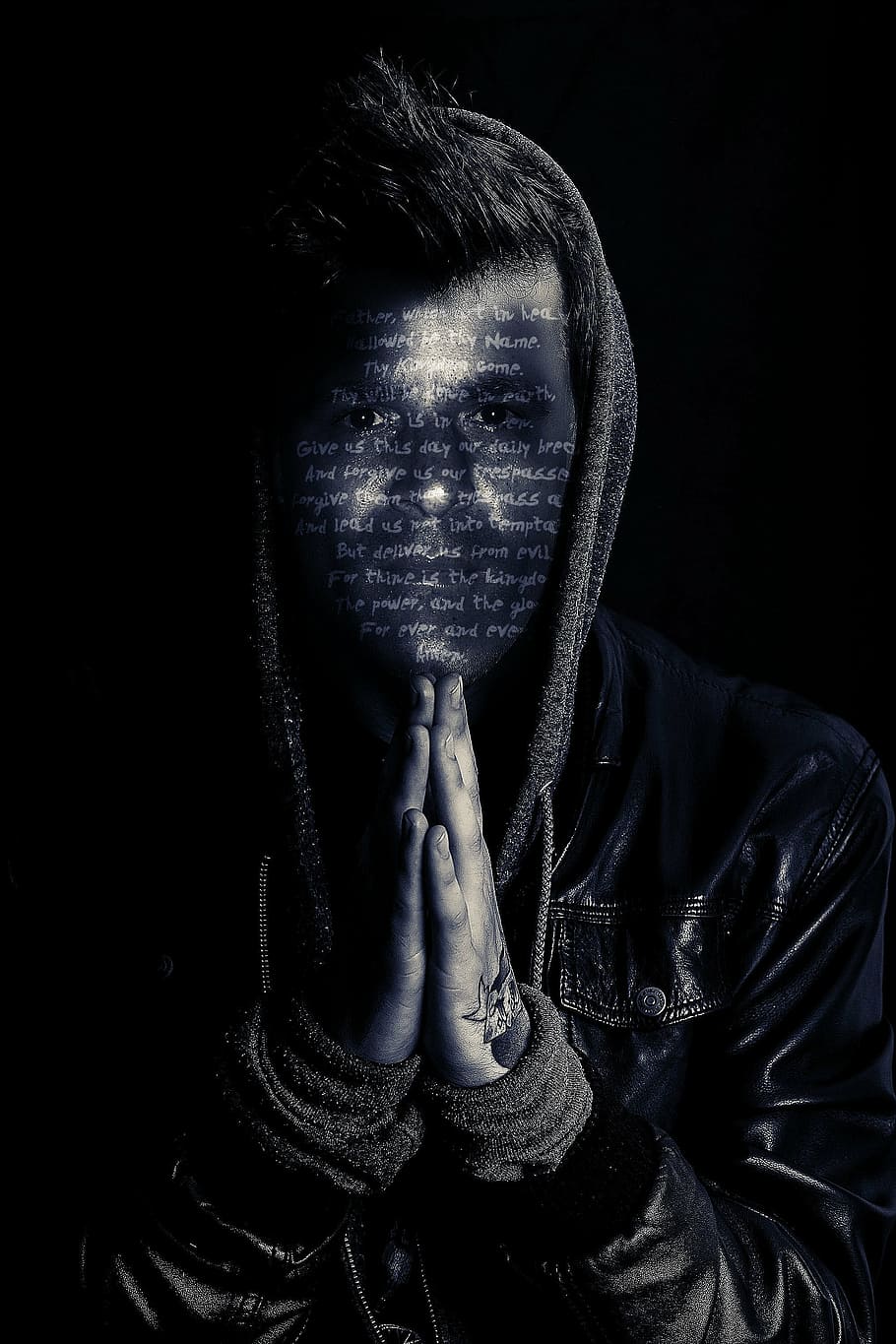 man wearing black hooded jacket with text overlay, pray, prayer