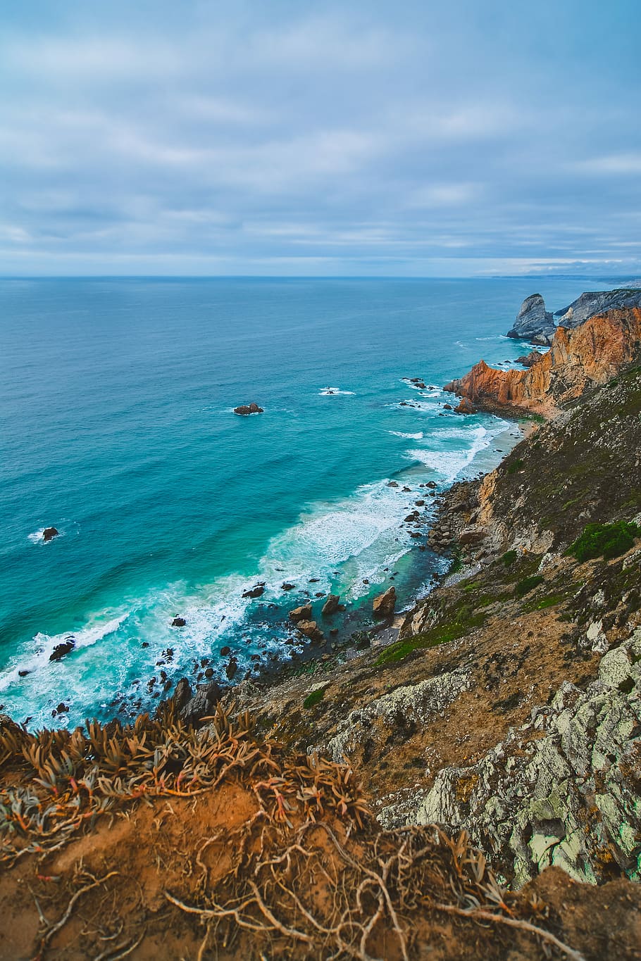 landscape photography of ocean near mountains, body of water beside mountain HD wallpaper