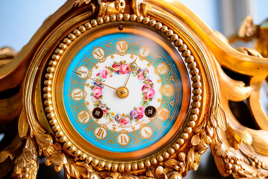gold torsion clock, brown floral clock displaying 12:50, colourfull