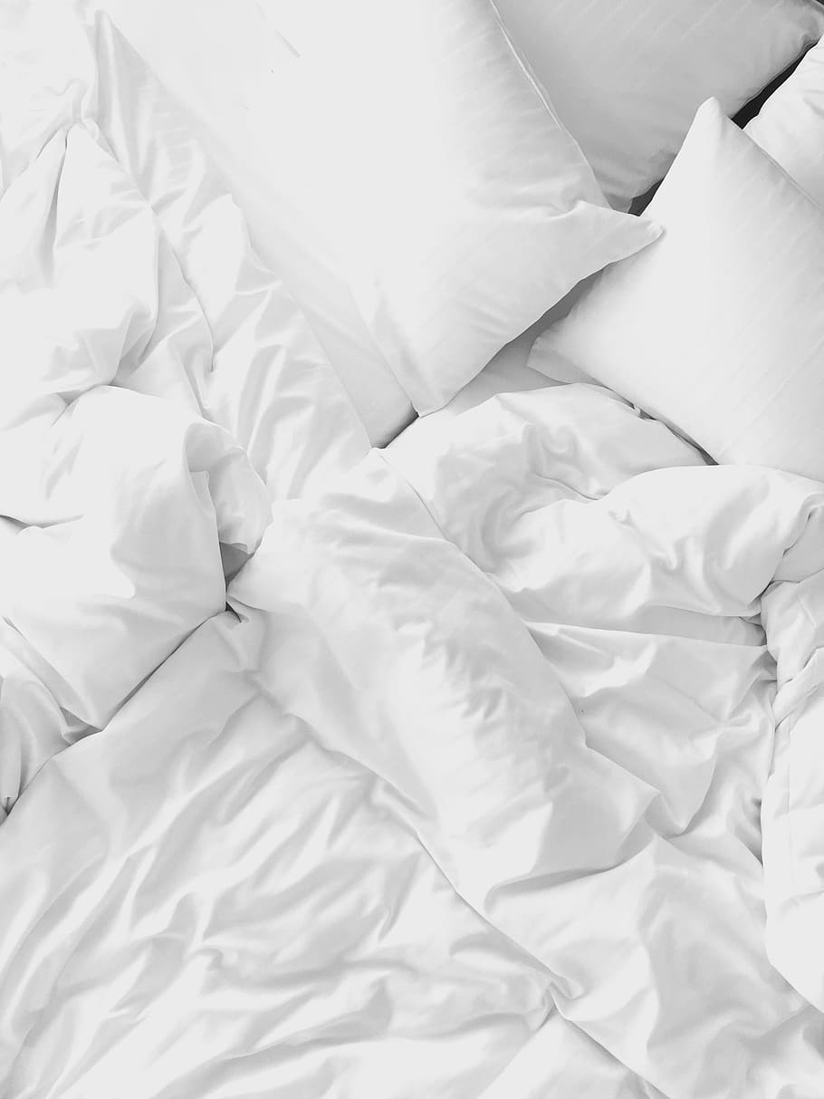 white pillows on bed, photo of crumpled bed linen set, sheet