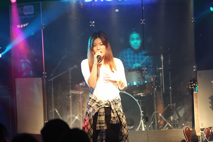 white top, stage, singer, performance, woman, girl, event, party HD wallpaper