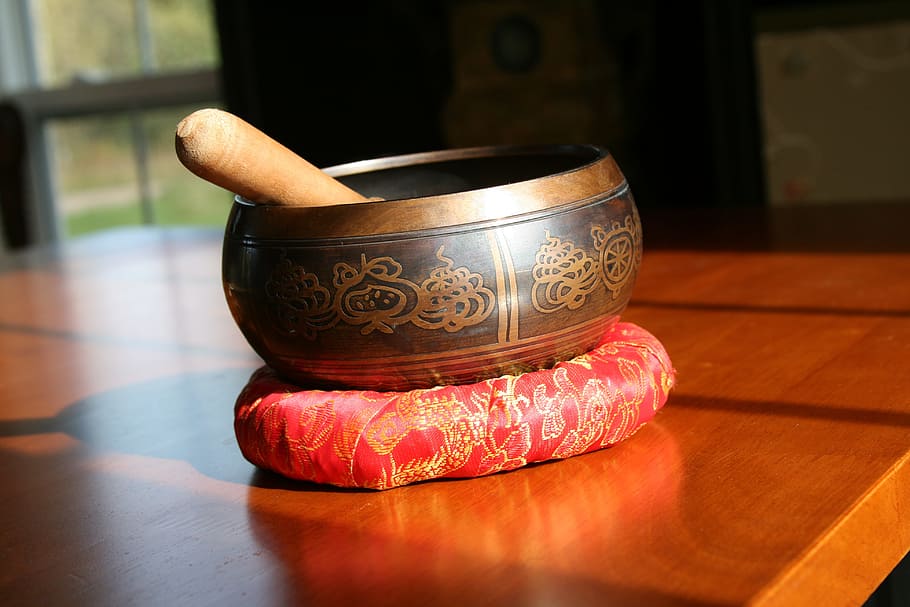 brown mortar and pestle on brown wooden table, tibetan, singing