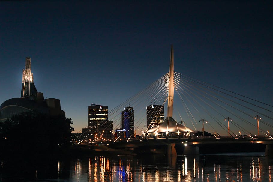 landscape photography of gray building with strings, bridge during night time HD wallpaper