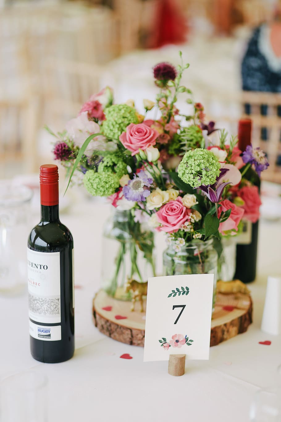 flower arrangement with wine bottle on the table, wine bottle near bouquet of flower on the table HD wallpaper