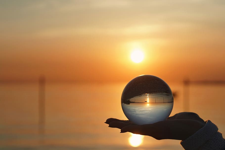 shallow focus photography of person holding crystal ball, sunset, HD wallpaper