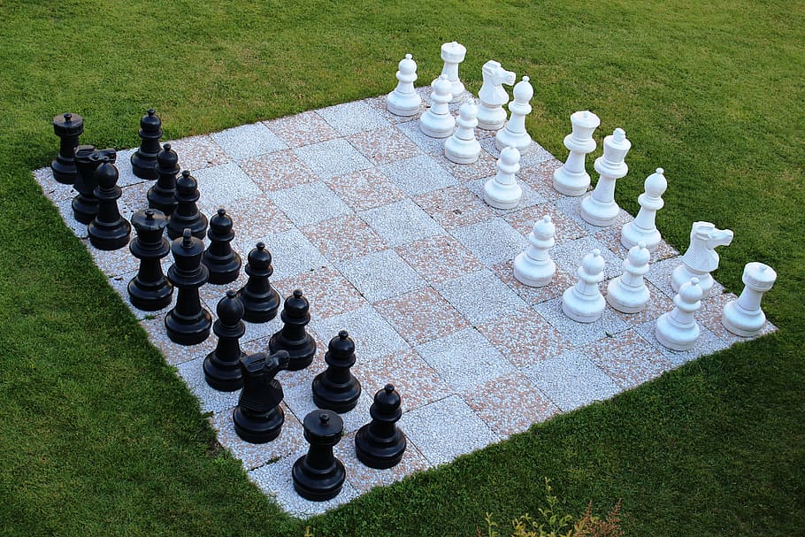 chessboard set on field of grass, chess game, garden chess, chess pieces