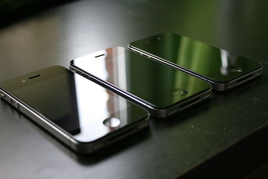 three black iPhone 4's on black surface, smartphone, mobile phone HD wallpaper