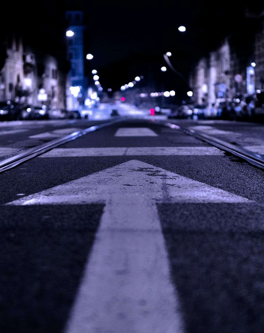 shallow focus photography of road with forward arrow illustration, worm's-eye view photography of road during nighttime