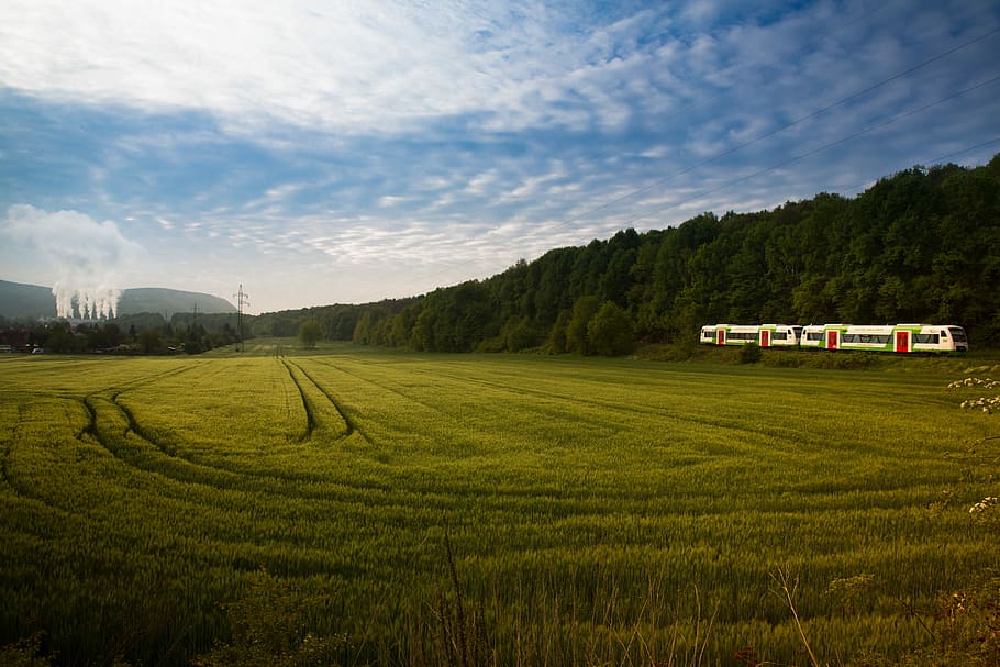 grassland surrounded with trees near train tracks with train, green grass field HD wallpaper